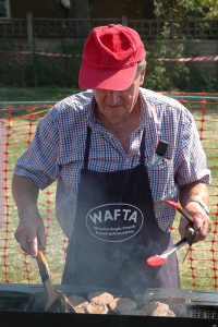 Image of one of the Winslow Anglo French Twinning Association members cooking meet on the WAFTA stall at Winslow Show.