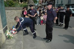 Image of French and British firemen laying a wreath at the War Memorial in Winslow during the biennial visit to Winslow organised by the Winslow Anglo French Twinning Association